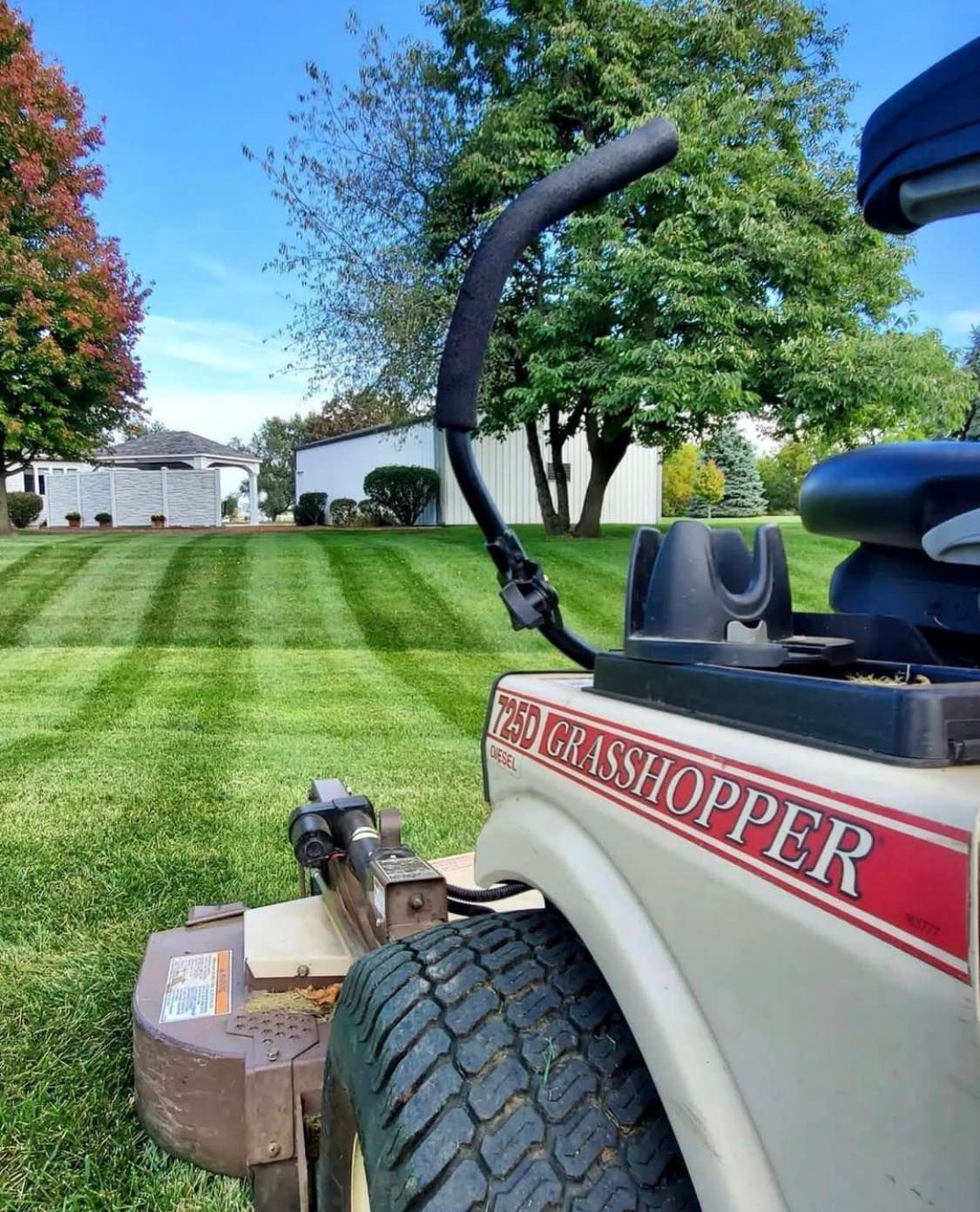 A Lawn Mower Is Cutting A Lush Green Lawn — Tracserv in Dubbo, NSW