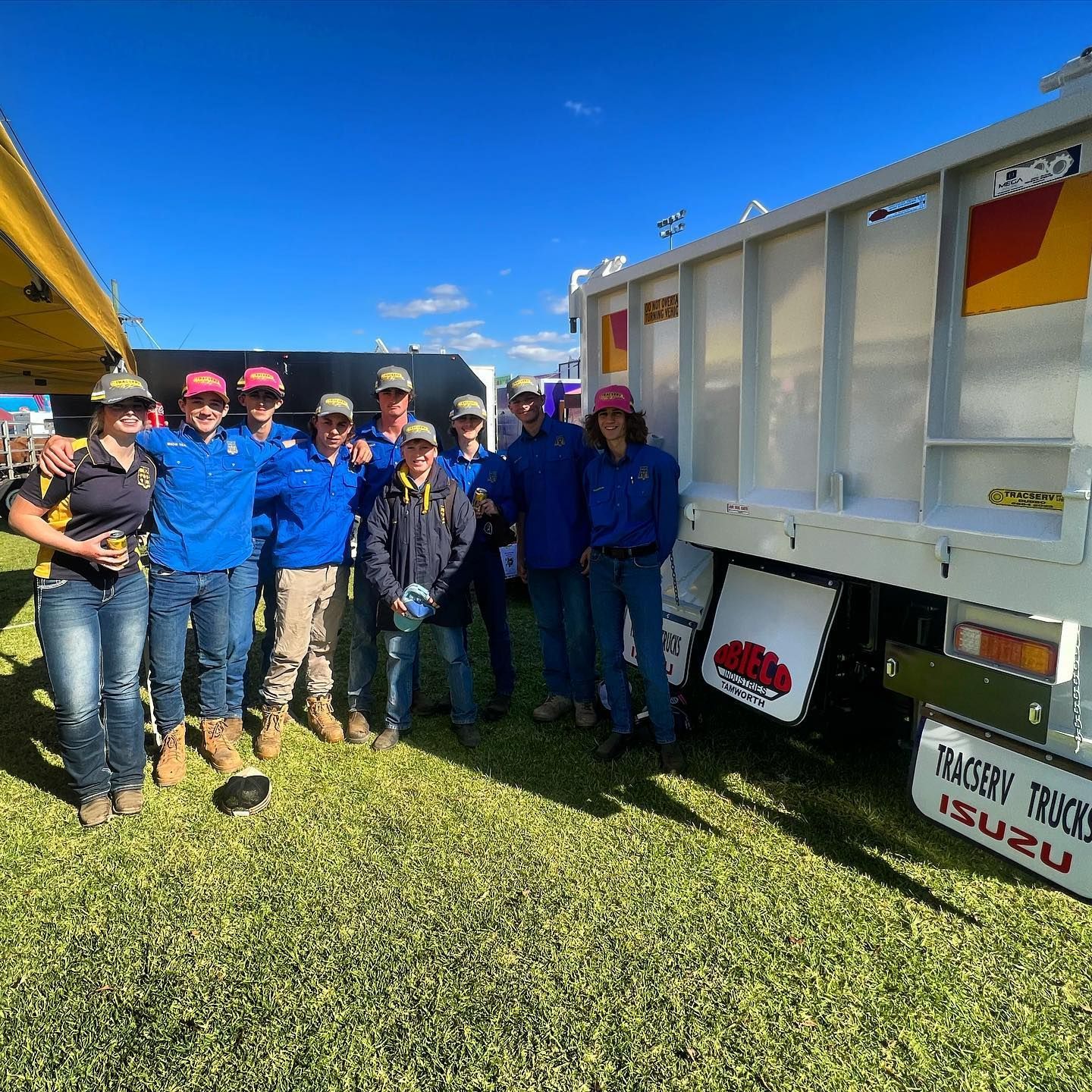 A Group Of People Are Posing For A Picture In Front Of A Truck — Tracserv in Forbes, NSW