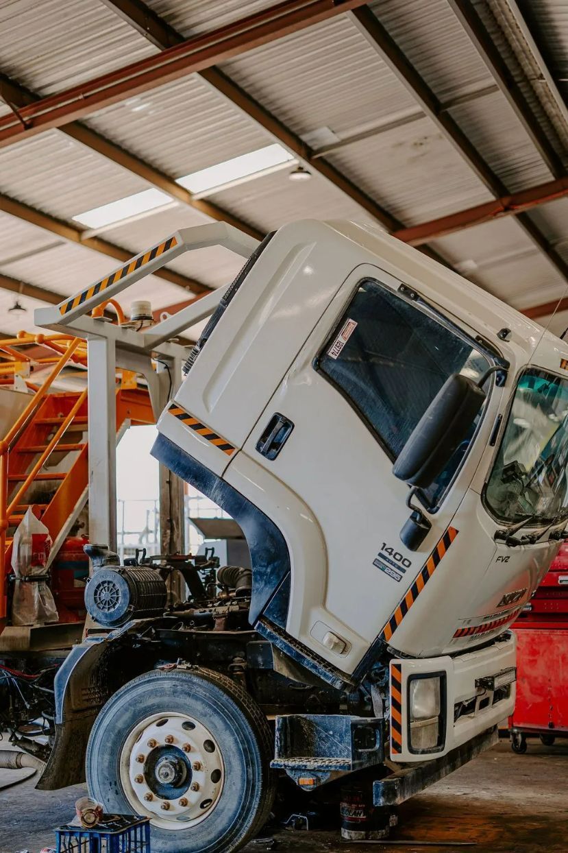 A Truck Is Being Repaired In A Garage With Its Hood Up — Tracserv in Bathurst, NSW