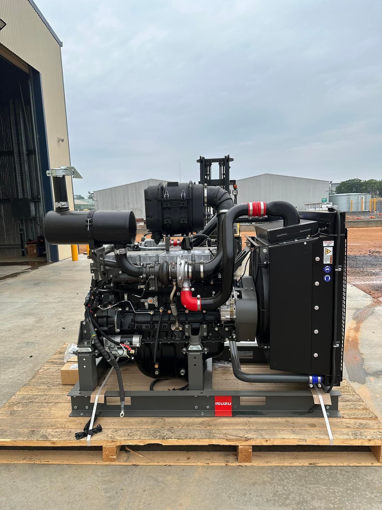 A Large Diesel Engine Is Sitting On Top Of A Wooden Pallet — Tracserv in Mudgee, NSW
