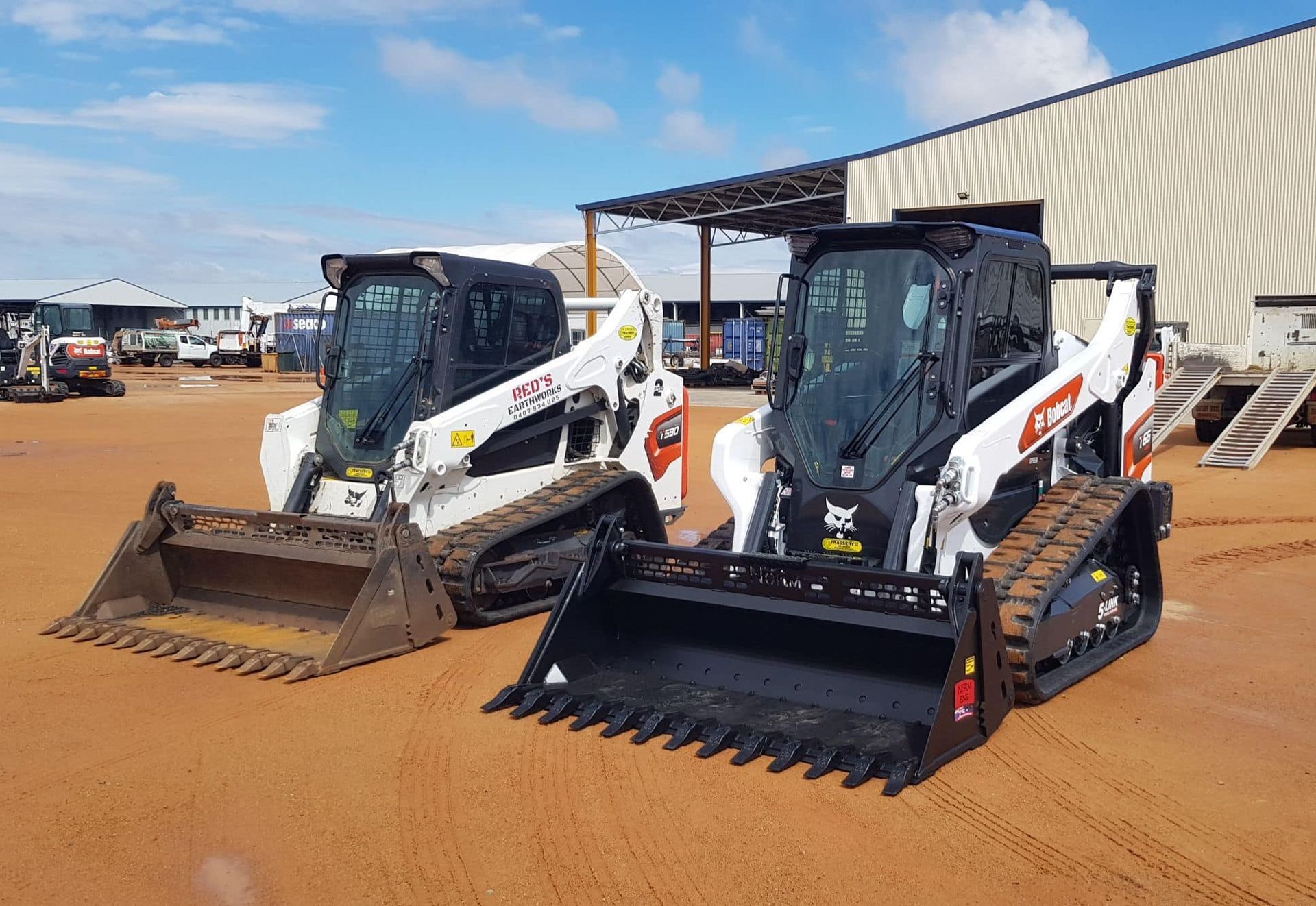 Two Bulldozers Are Parked Next To Each Other In Front Of A Building — Tracserv in Bourke, NSW