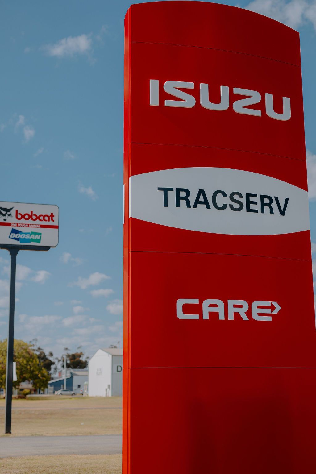 A Red And White Sign That Says Isuzu Tracserv Care — Tracserv in Dubbo, NSW