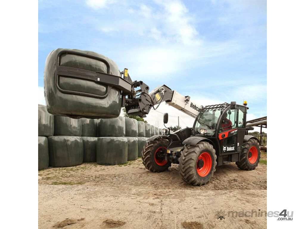Tractor Loading Large Wrapped Hay Bales Onto a Stack — Tracserv in Dubbo, NSW