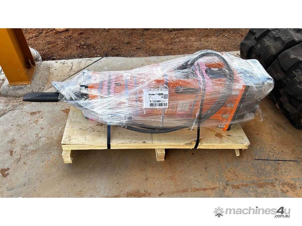 Shrink-wrapped Orange Industrial Machine on a Wooden Pallet Outdoors — Tracserv in Dubbo, NSW