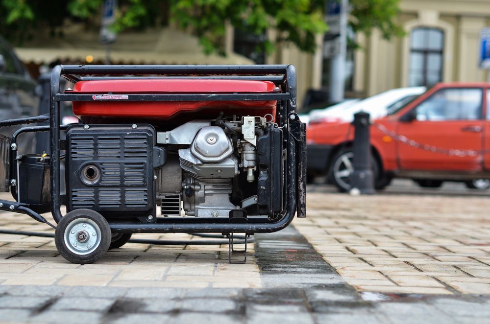 A Portable Generator Is Parked On The Sidewalk Next To A Car — Tracserv in Dubbo, NSW