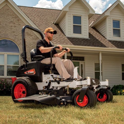 Man Operating a Bobcat Zero-Turn Lawnmower on A Grassy Yard Near a House — Tracserv in Dubbo, NSW