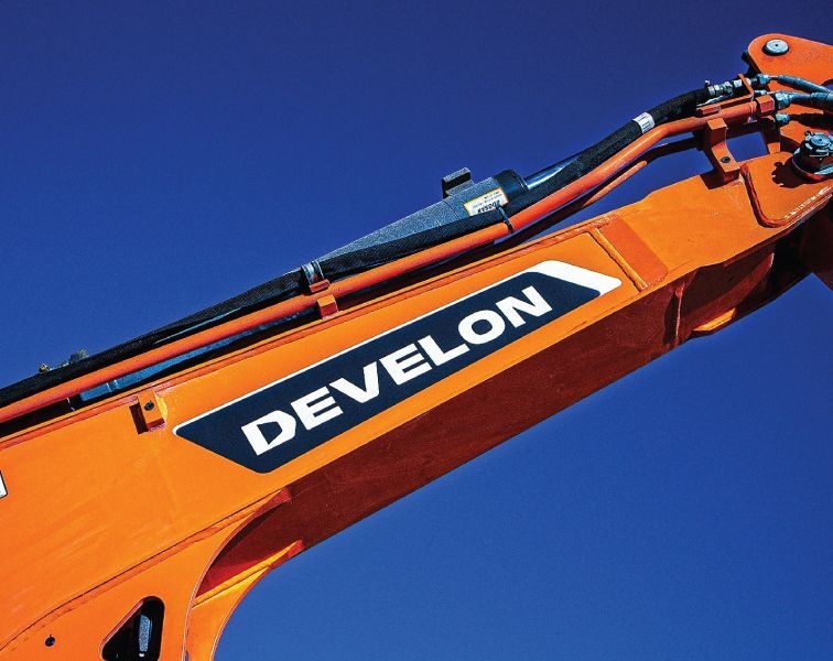 An Orange Develon Crane Against A Blue Sky — Tracserv in Dubbo, NSW