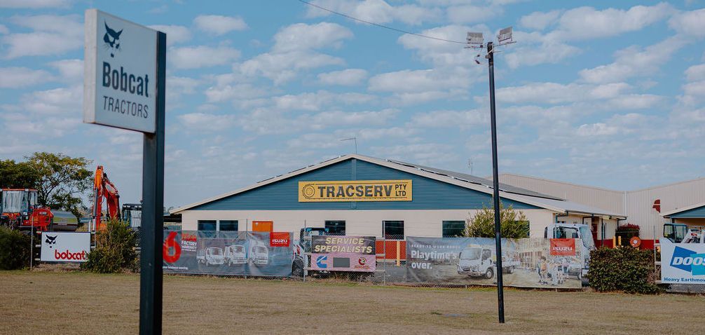 A Tracserv Pty Ltd Building With Isuzu And Bobcat Service Specialist Signage — Tracserv in Dubbo, NSW