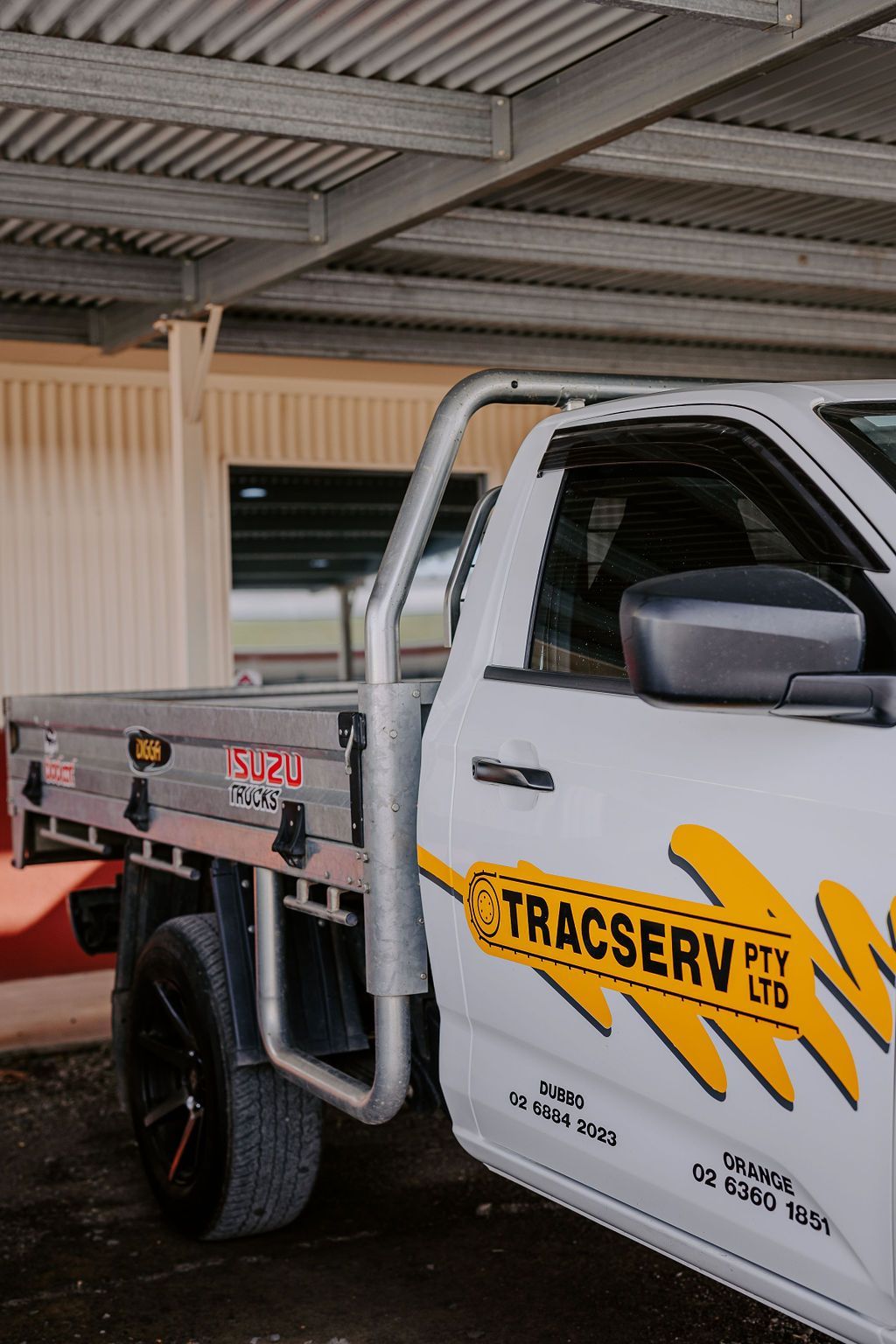 A White Truck With The Word Tracserv On The Side Is Parked Under A Roof — Tracserv in Dubbo, NSW