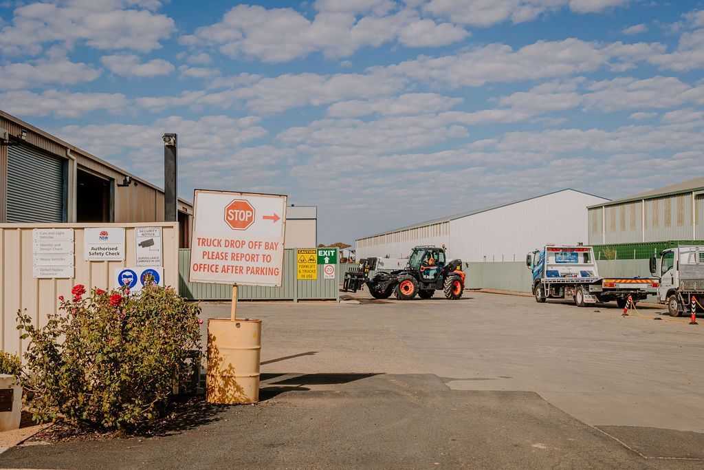 A Tractor Is Parked In A Parking Lot In Front Of A Building — Tracserv in Dubbo, NSW