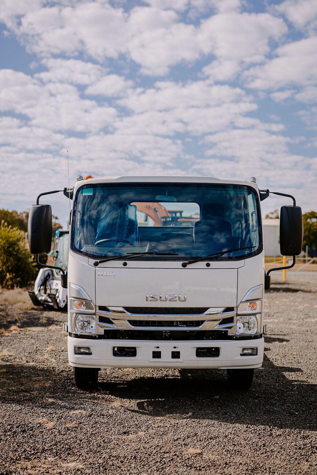 A White Truck Is Parked In A Gravel Lot — Tracserv in Orange, NSW