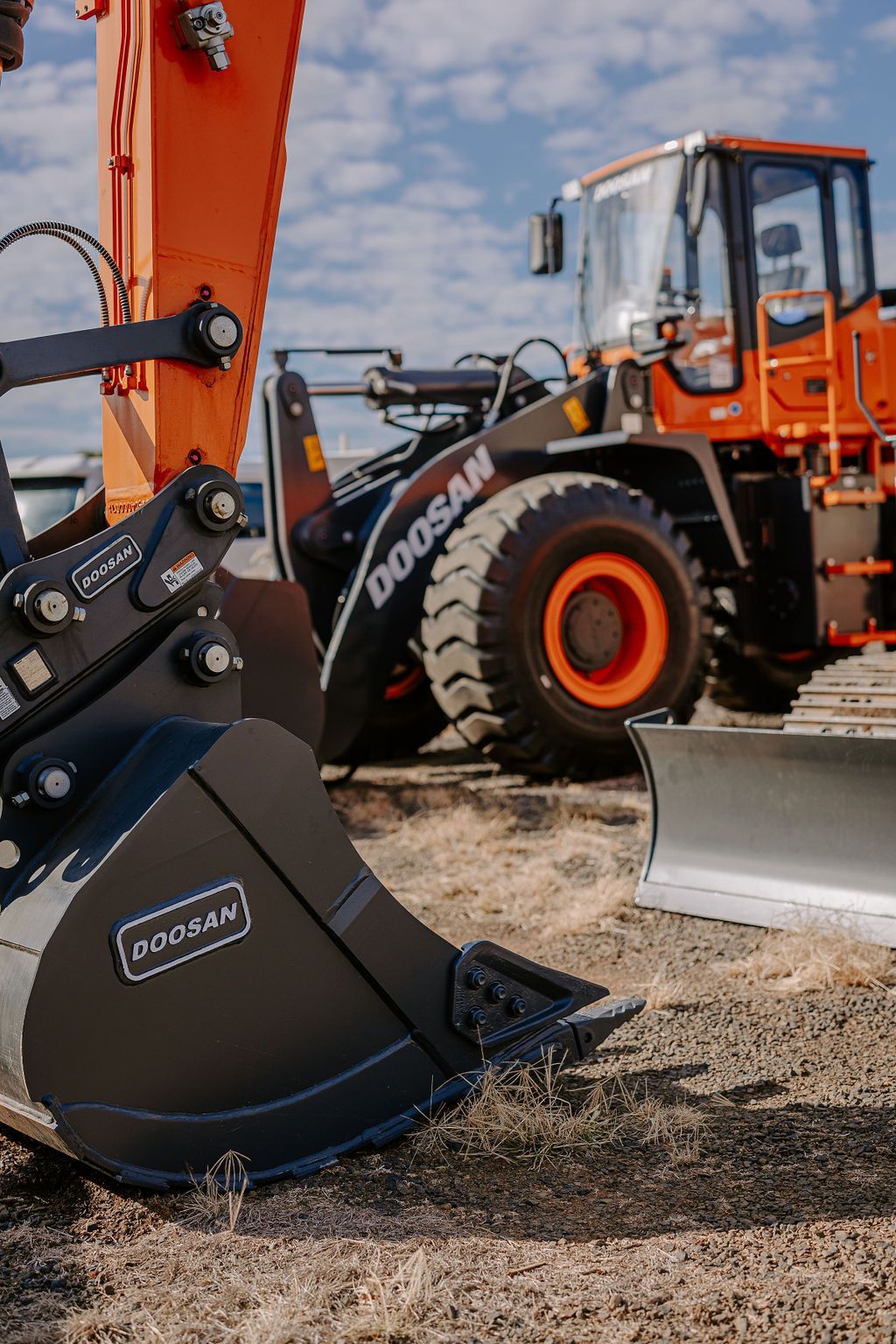 A Bulldozer And A Bucket Are Parked Next To Each Other On A Dirt Field — Tracserv in Bathurst, NSW