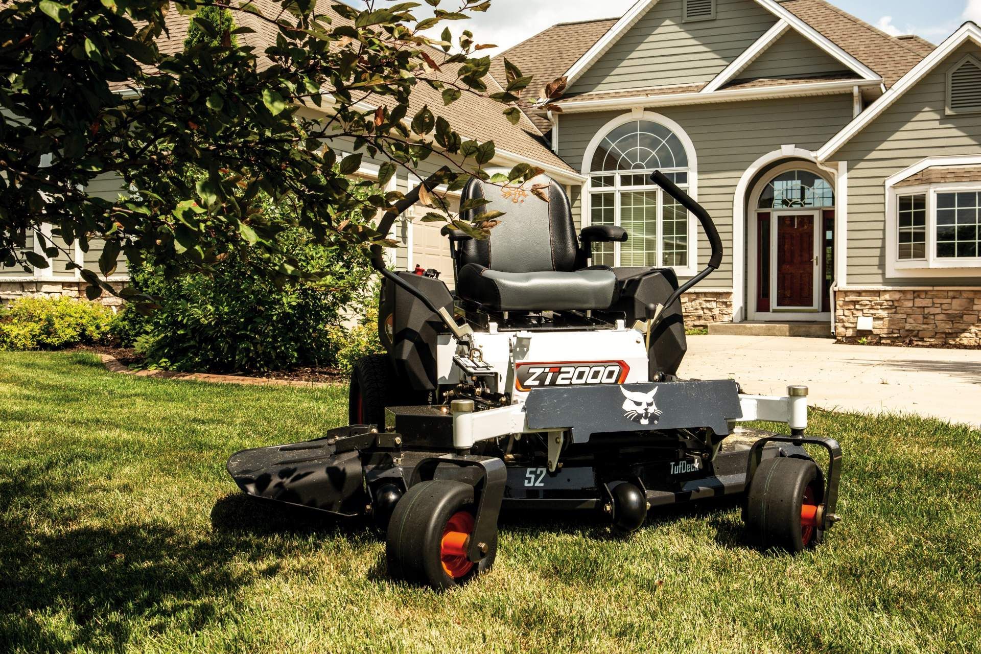 A Lawn Mower Is Parked In Front Of A House — Tracserv in Mudgee, NSW