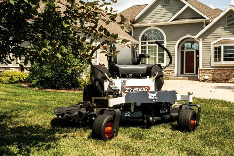 A Lawn Mower Is Parked In Front Of A House — Tracserv in Orange, NSW