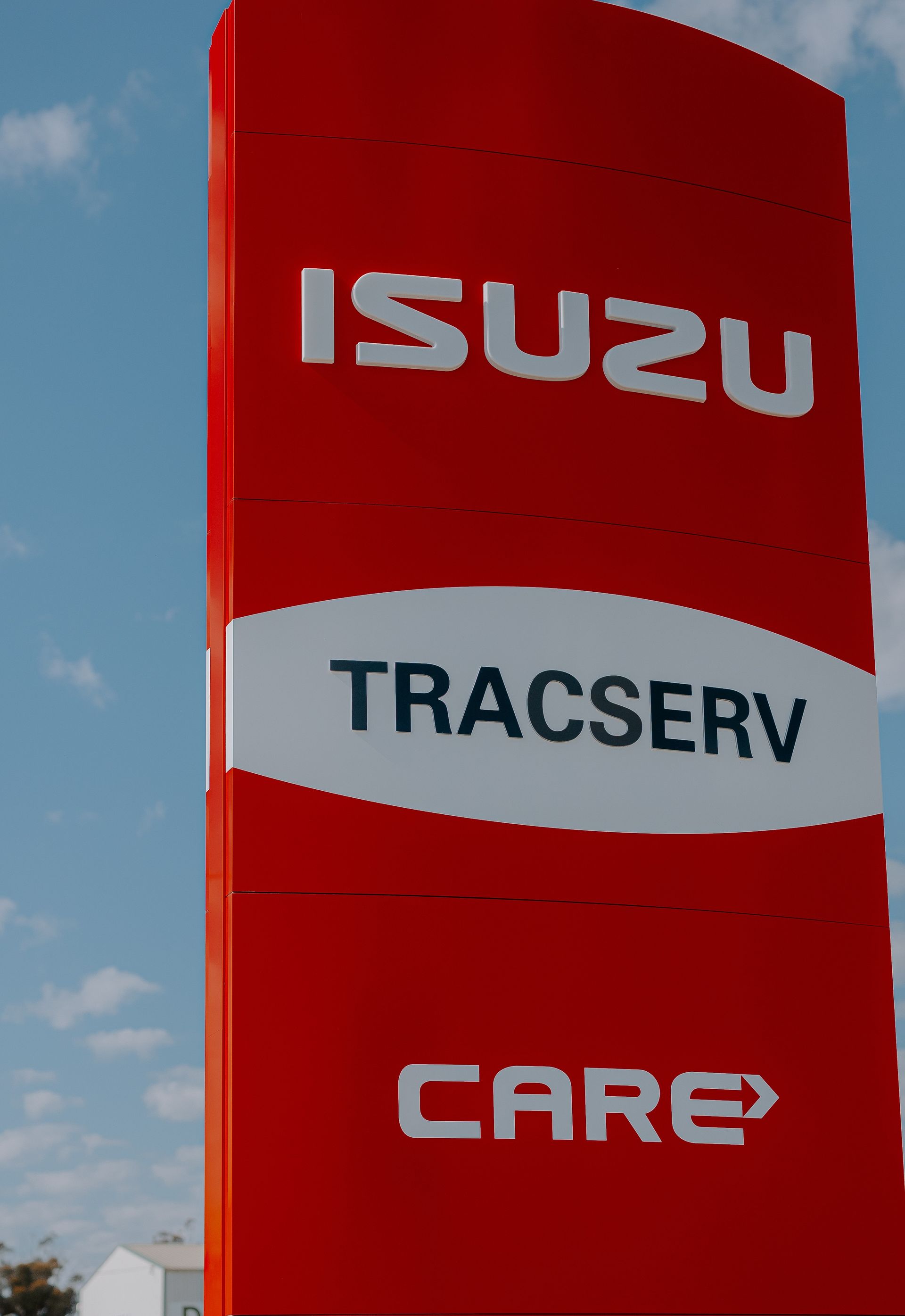 A red and white sign for isuzu tracserv care