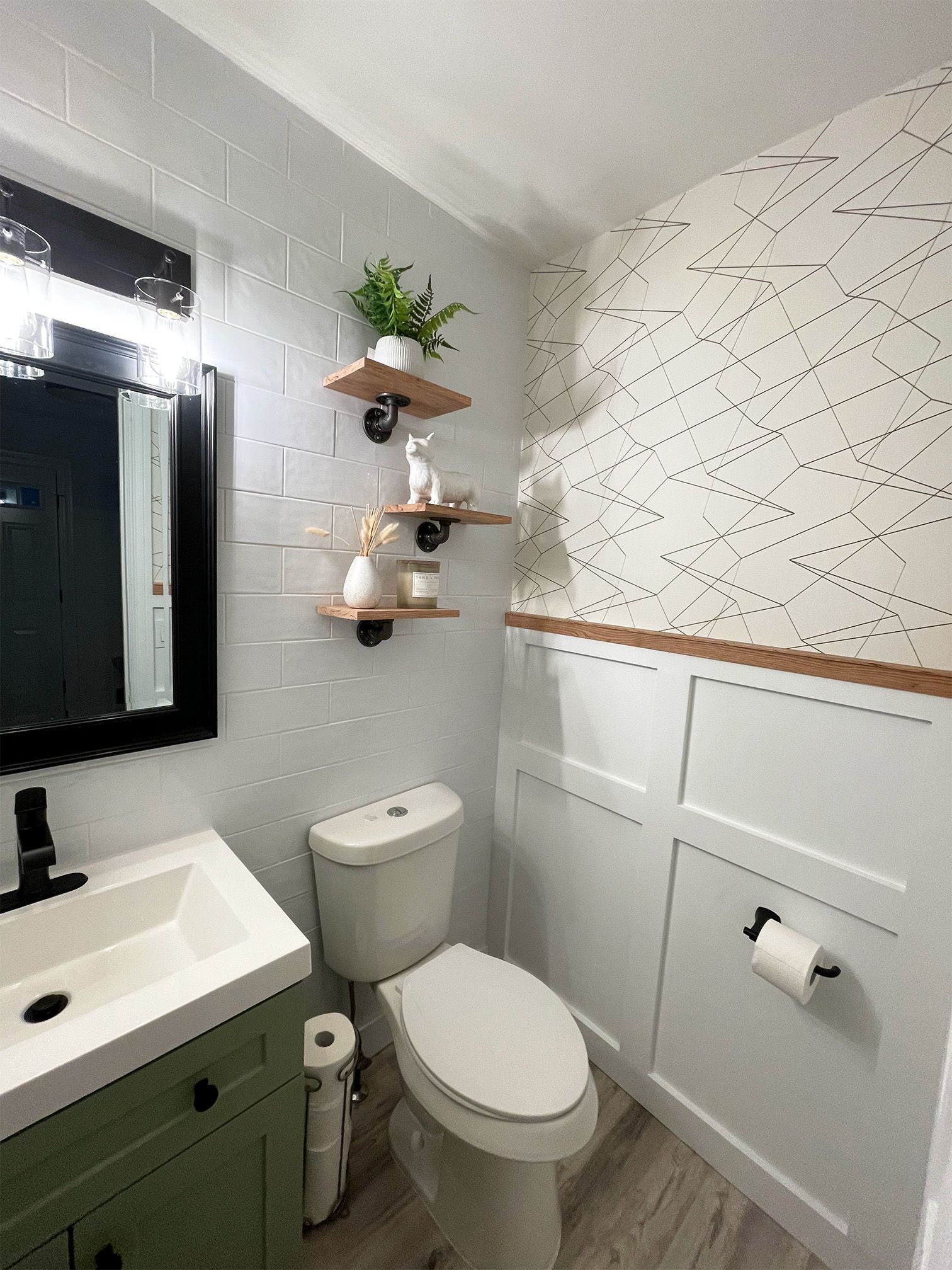 a bathroom with a toilet , sink and mirror nvrrete design