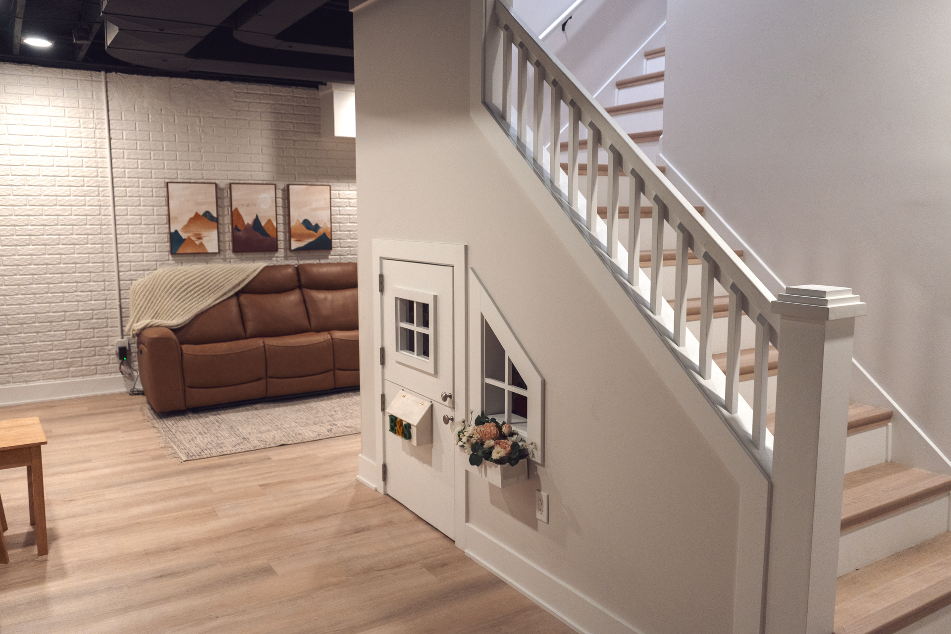 There is a playhouse under the stairs in the basement.