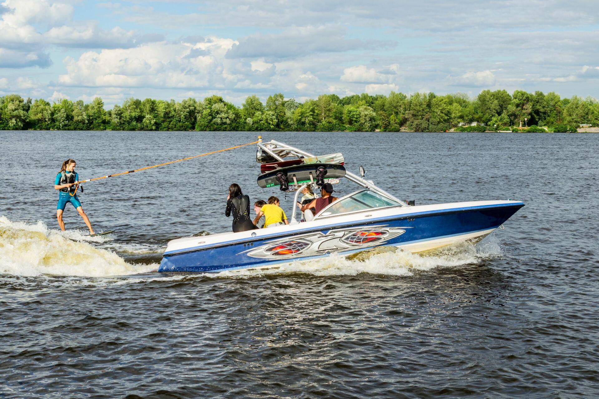 A group of people are water skiing on a lake.