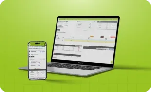 Laptop prateado exibindo uma planilha sobre um fundo verde brilhante.