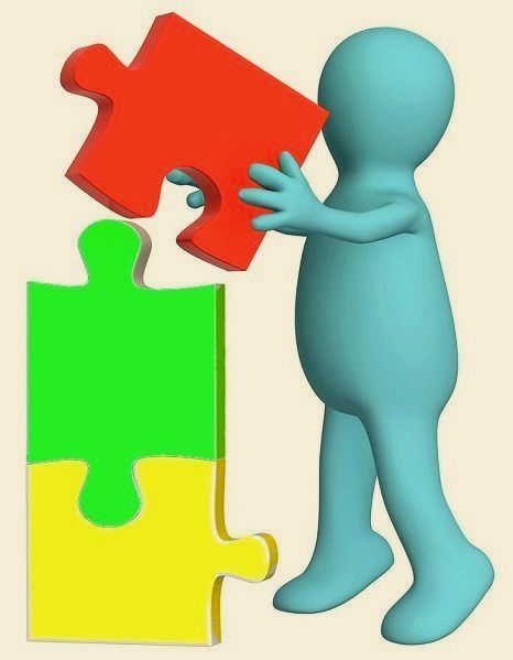 blue man with large colourful jigsaw pieces