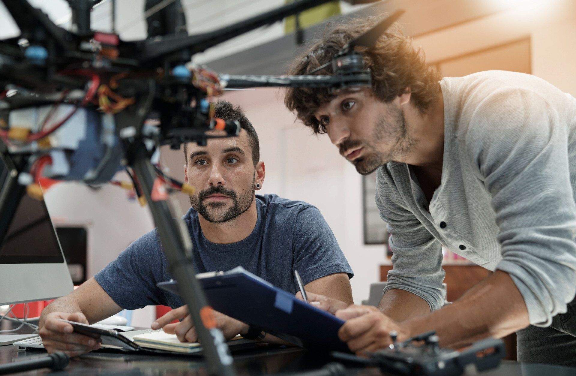 Two electronics engineer designers looking at an electronic drone device