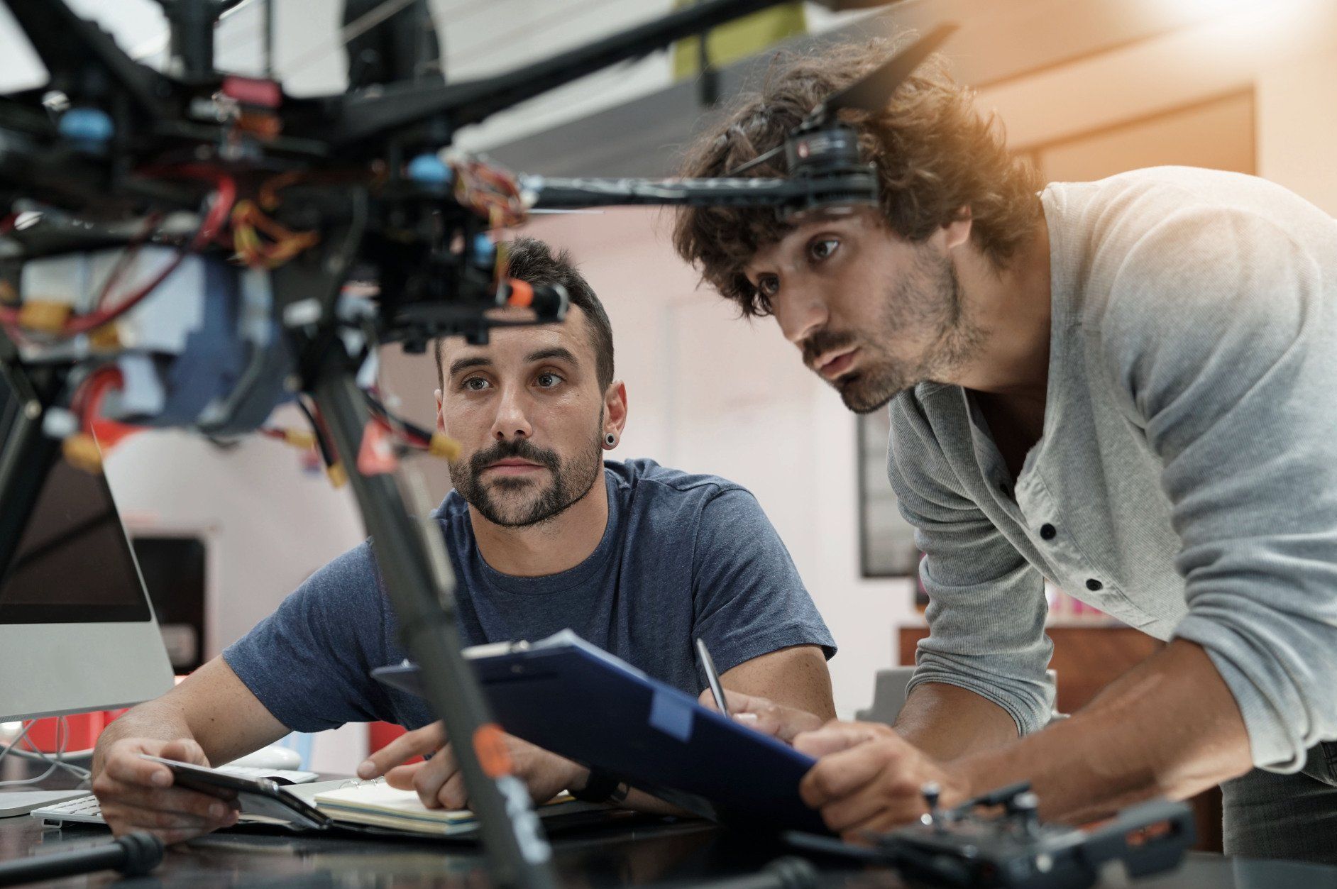 two electronics engineers observing a drone prototype