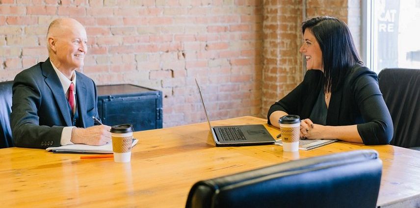 lady sitting down at a meeting with two other people