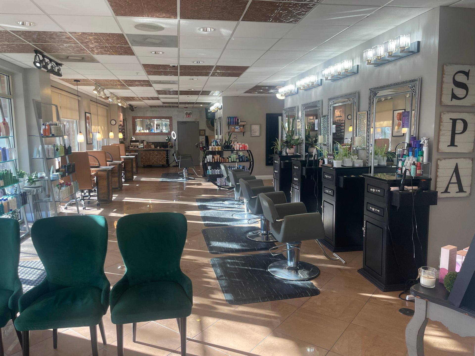 A salon with green chairs and a sign that says spa