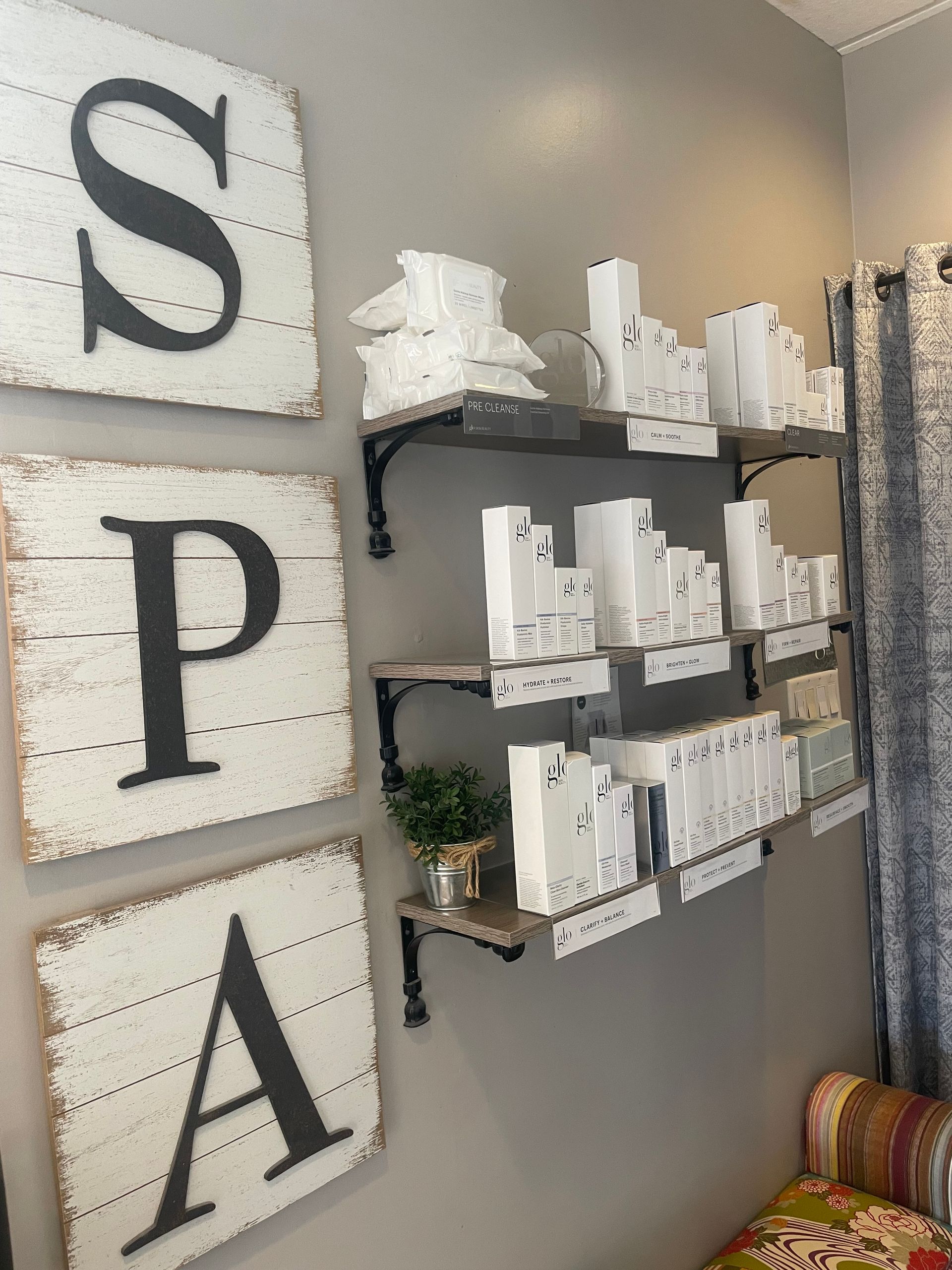 A room with shelves and signs on the wall that say spa