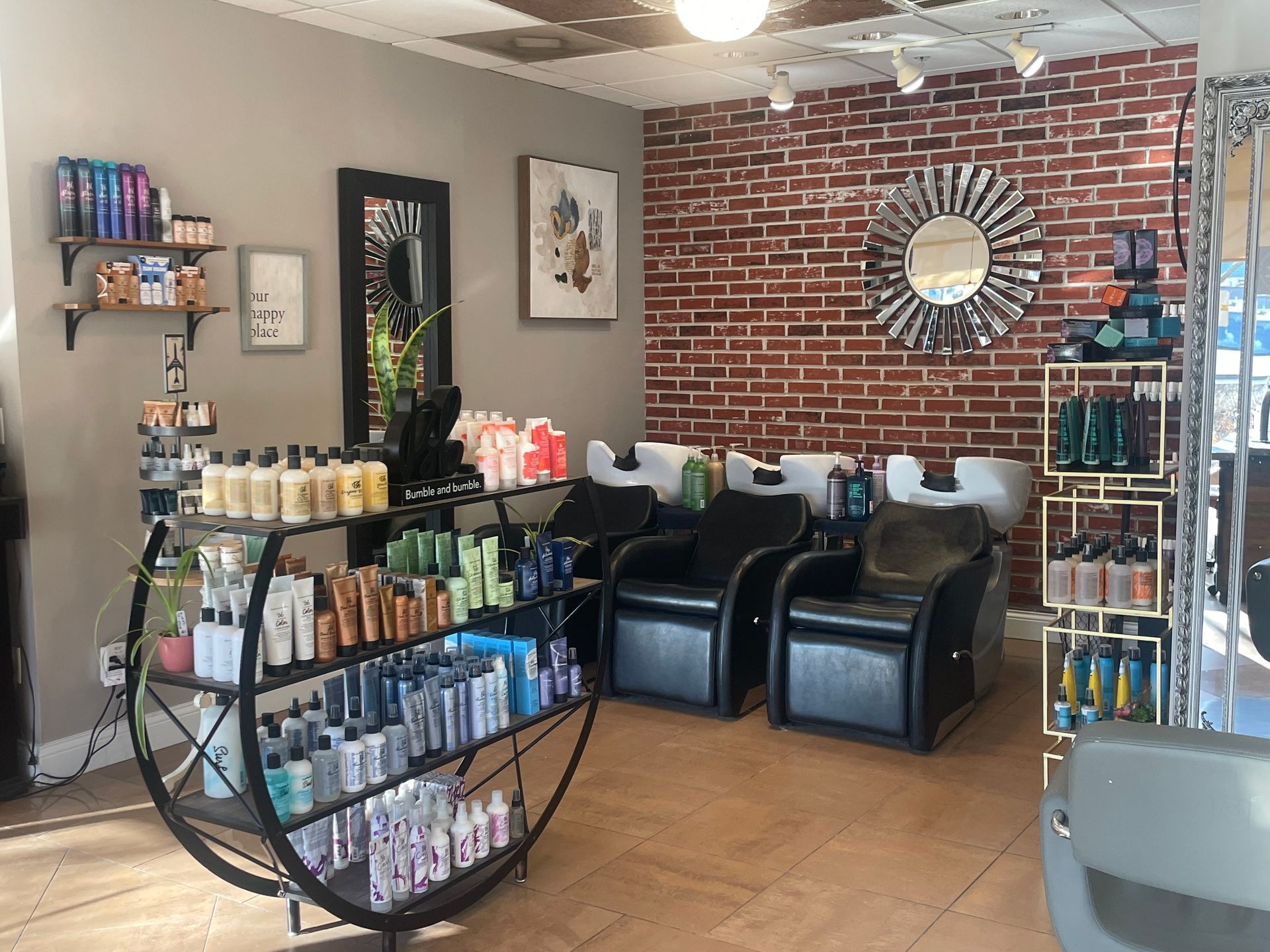 A wooden counter in a room with a brick wall behind it.