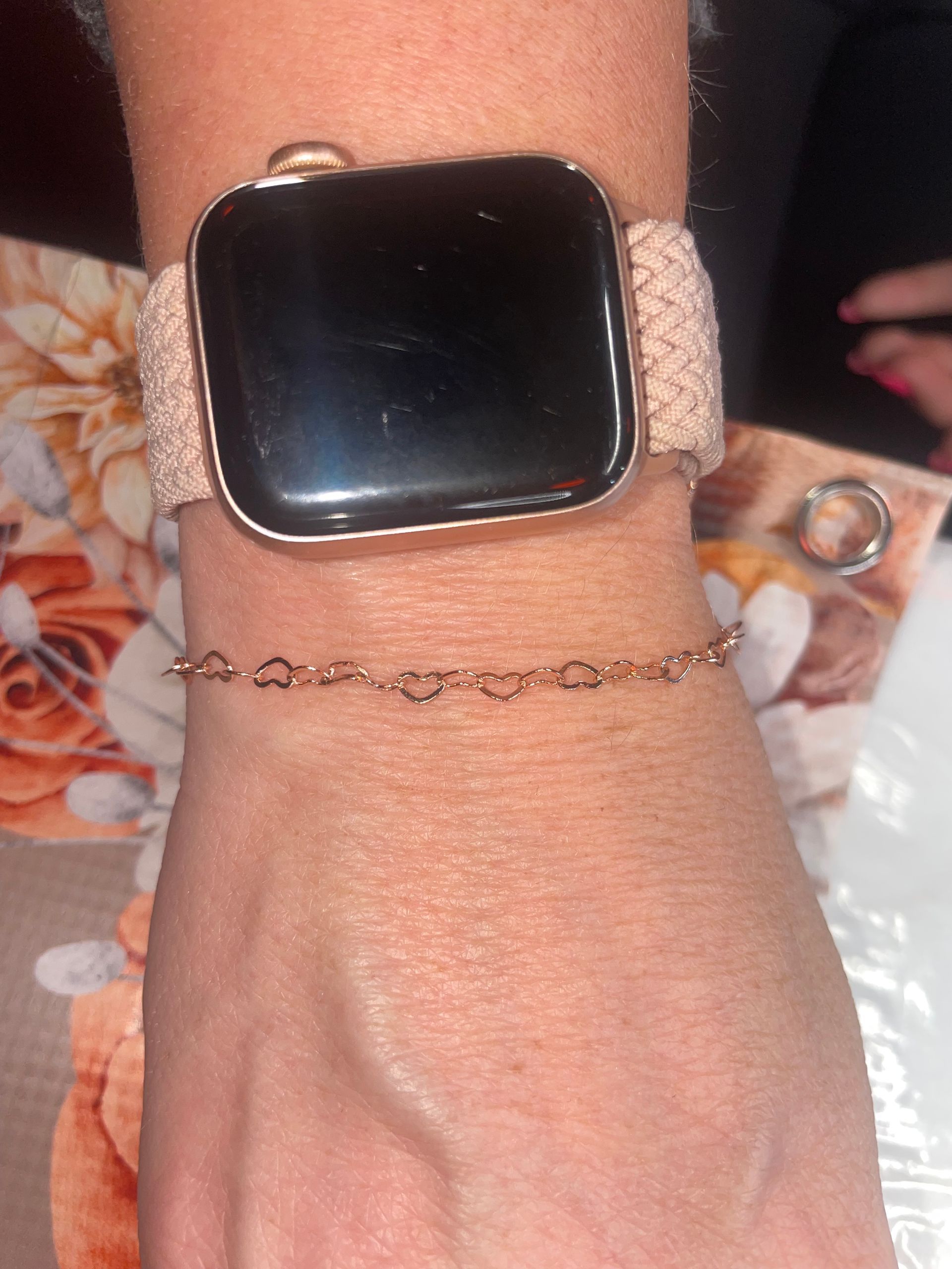 A woman wearing a ring and a bracelet on her wrist