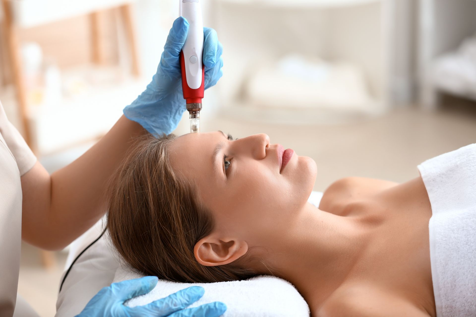 A woman is getting a facial treatment in a beauty salon.