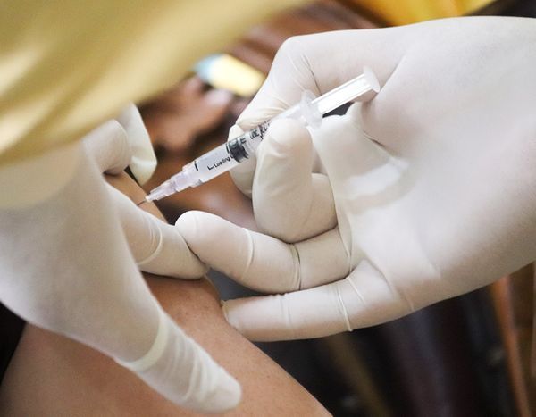 a person is getting an injection in their arm