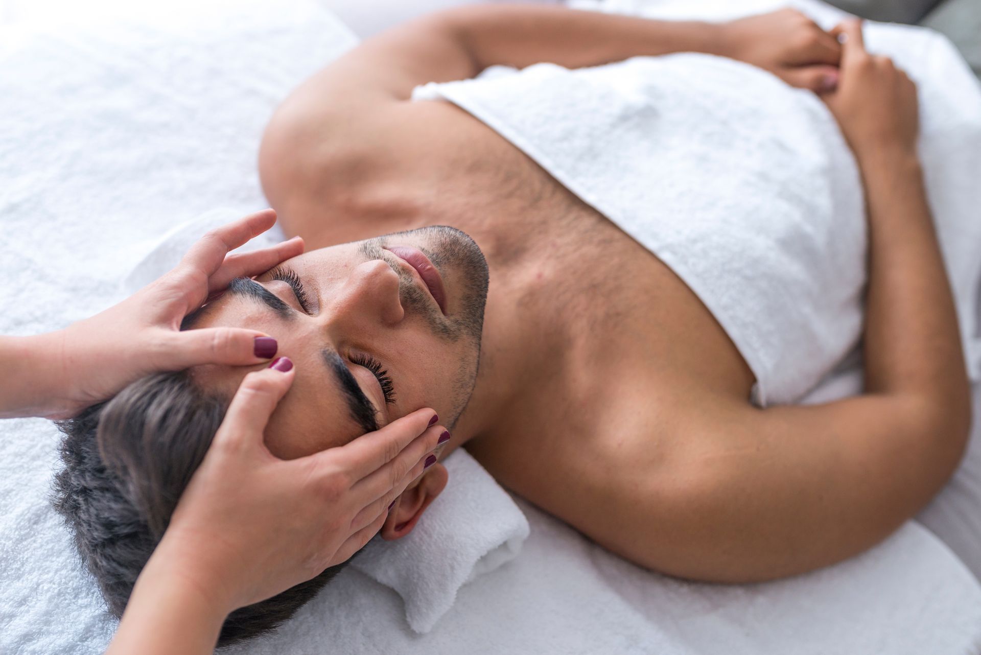 a man is getting a head massage at a spa .