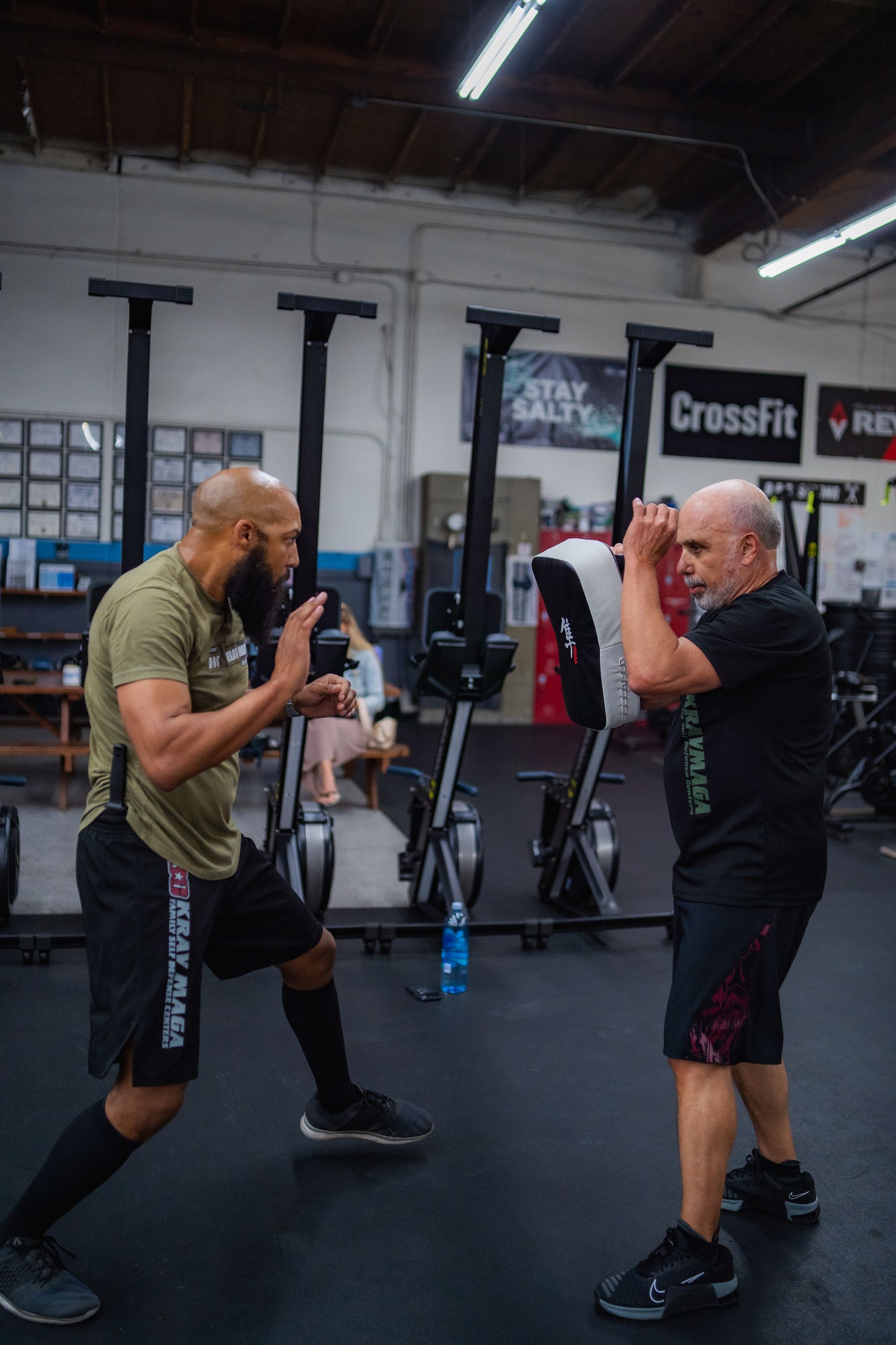 Two men are boxing in a gym.