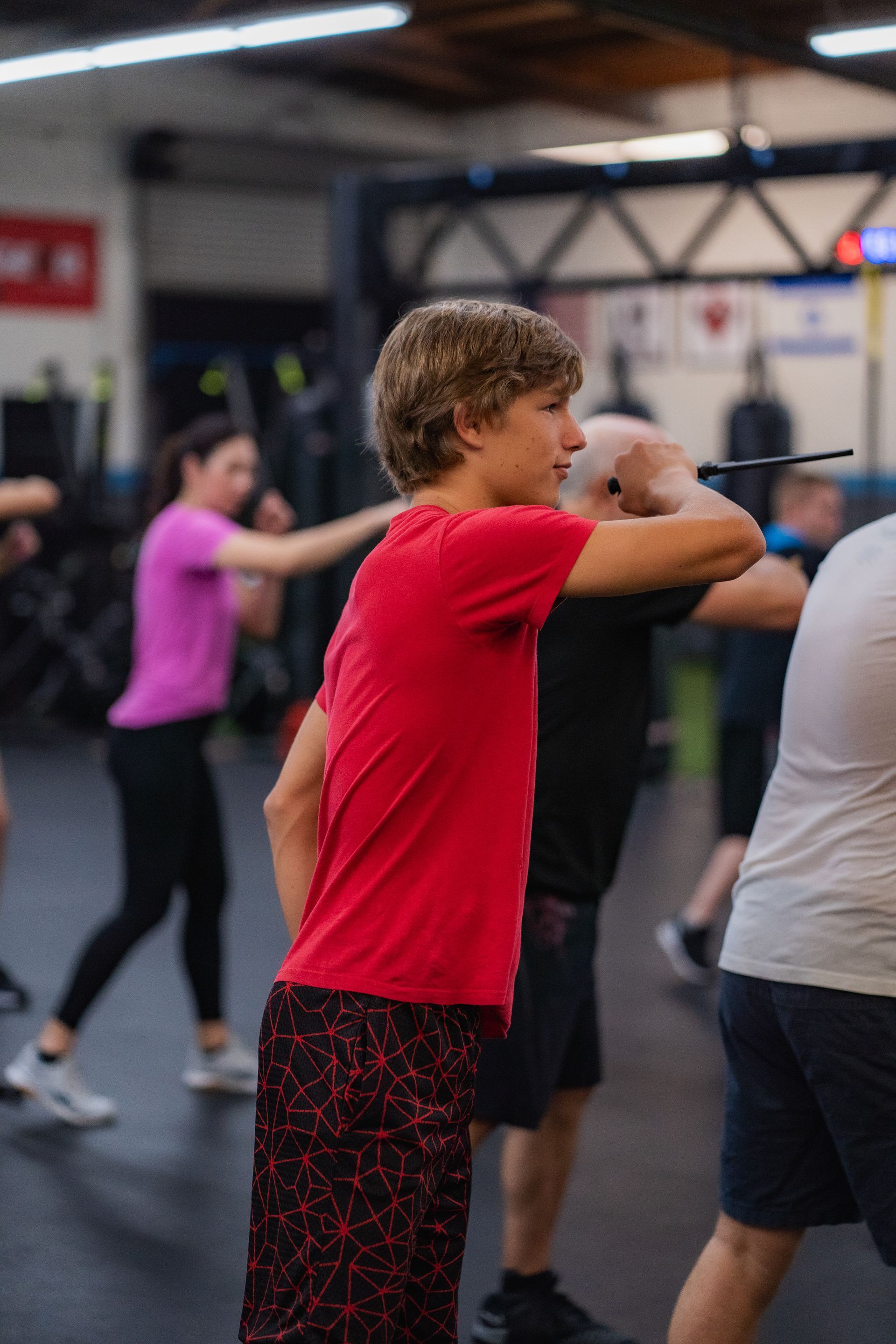 A group of people are boxing in a gym.