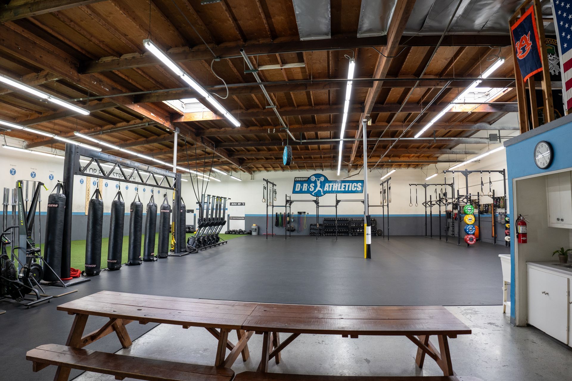 There is a picnic table in the middle of the gym.