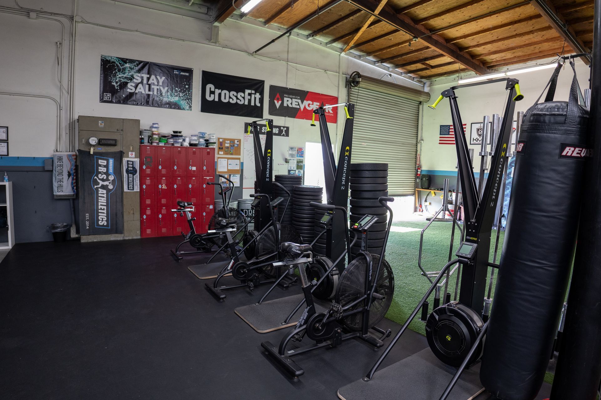 A gym filled with lots of exercise equipment and a boxing bag.