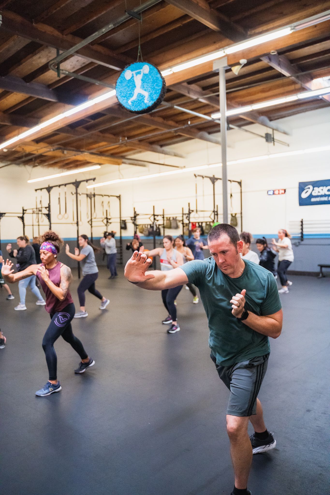 A group of people are boxing in a gym.