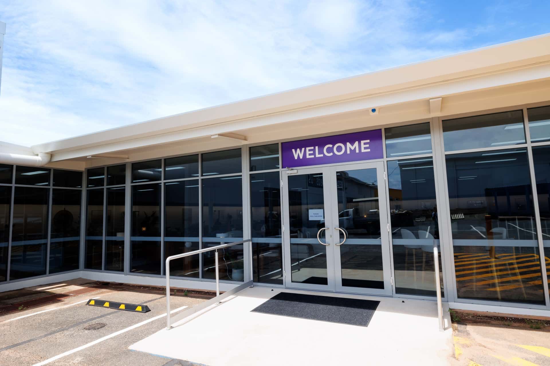 The Front of a Building With a Welcome Sign on It — The Comfort Zone Darwin In Winnellie, NT