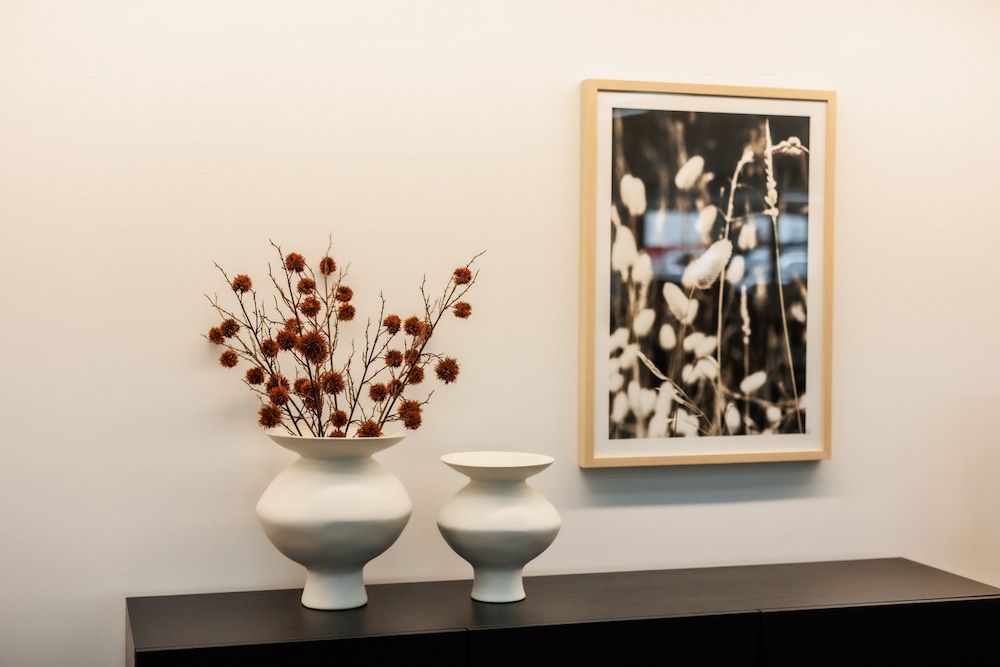 Two Vases Are Sitting on a Table Next to a Picture on the Wall — The Comfort Zone Darwin In Winnellie, NT