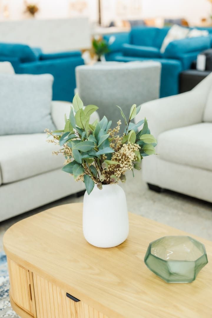 A Vase of Flowers is Sitting on a Wooden Table in a Living Room — The Comfort Zone Darwin In Winnellie, NT