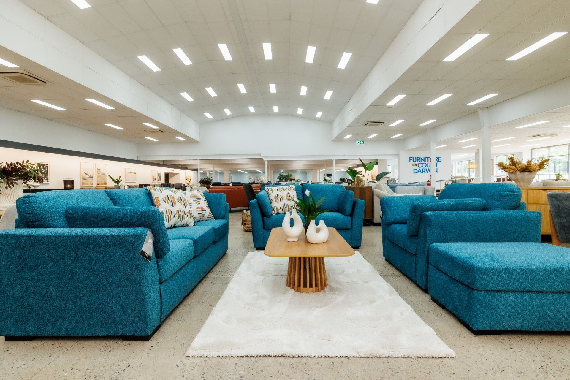 A Living Room Filled With Blue Couches, Chairs, and a Coffee Table — The Comfort Zone Darwin In Winnellie, NT
