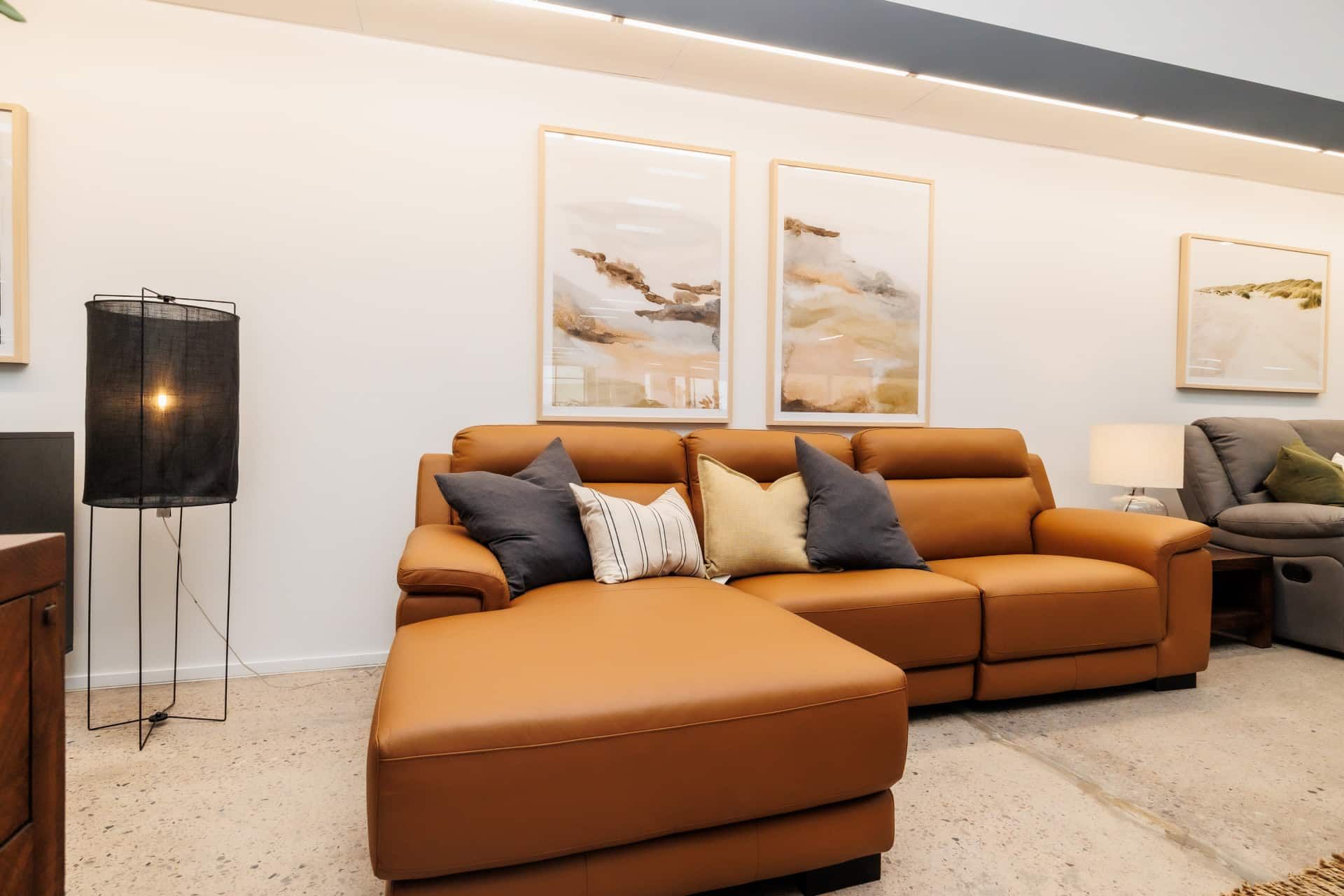 A Living Room With a Brown Leather Couch and Ottoman — The Comfort Zone Darwin In Winnellie, NT