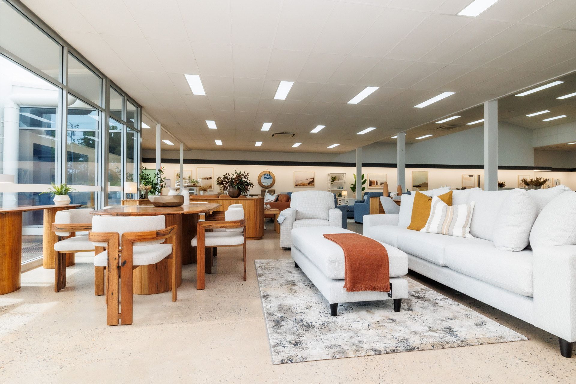 A Living Room With a White Couch, Chairs, Table and Rug — The Comfort Zone Darwin In Winnellie, NT