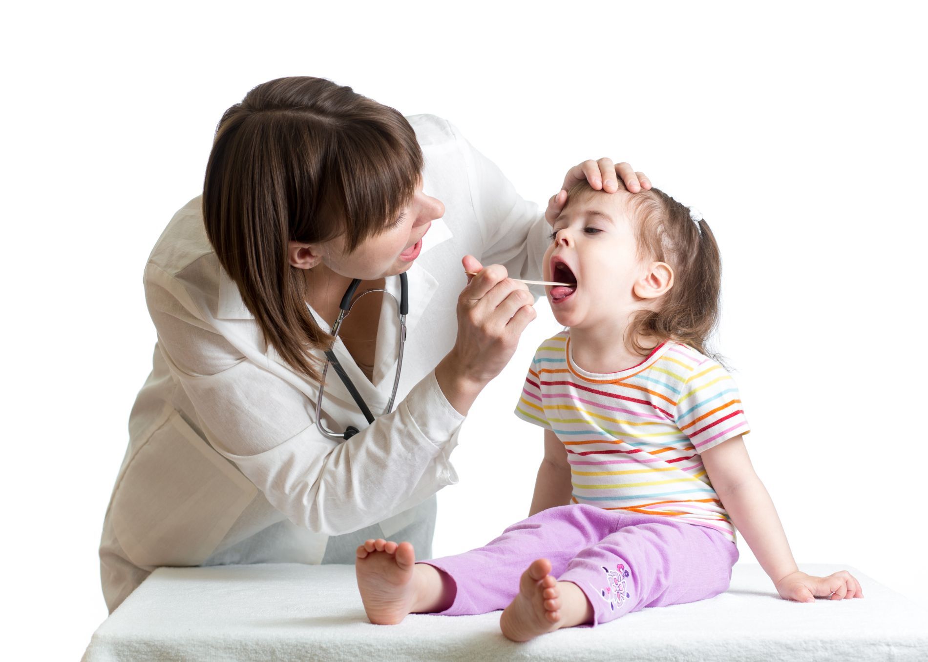 A doctor examining a young child's tonsils