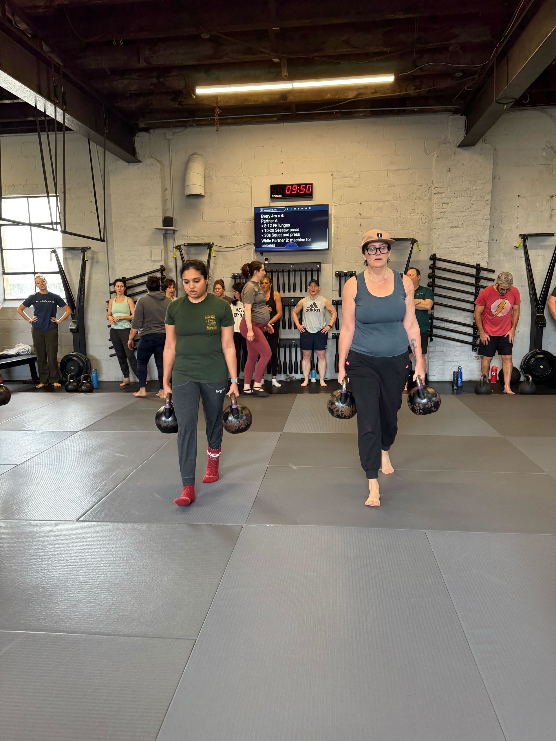 Coach guiding a small group workout at Soma MVMT in Maplewood, NJ, and building strength, mobility.