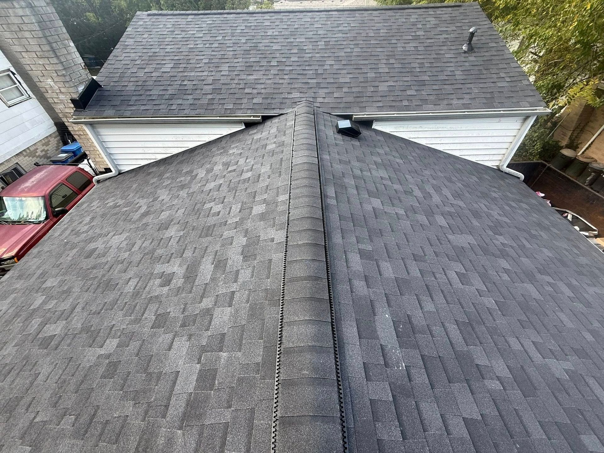 Overhead view of a dark gray asphalt shingle roof.
