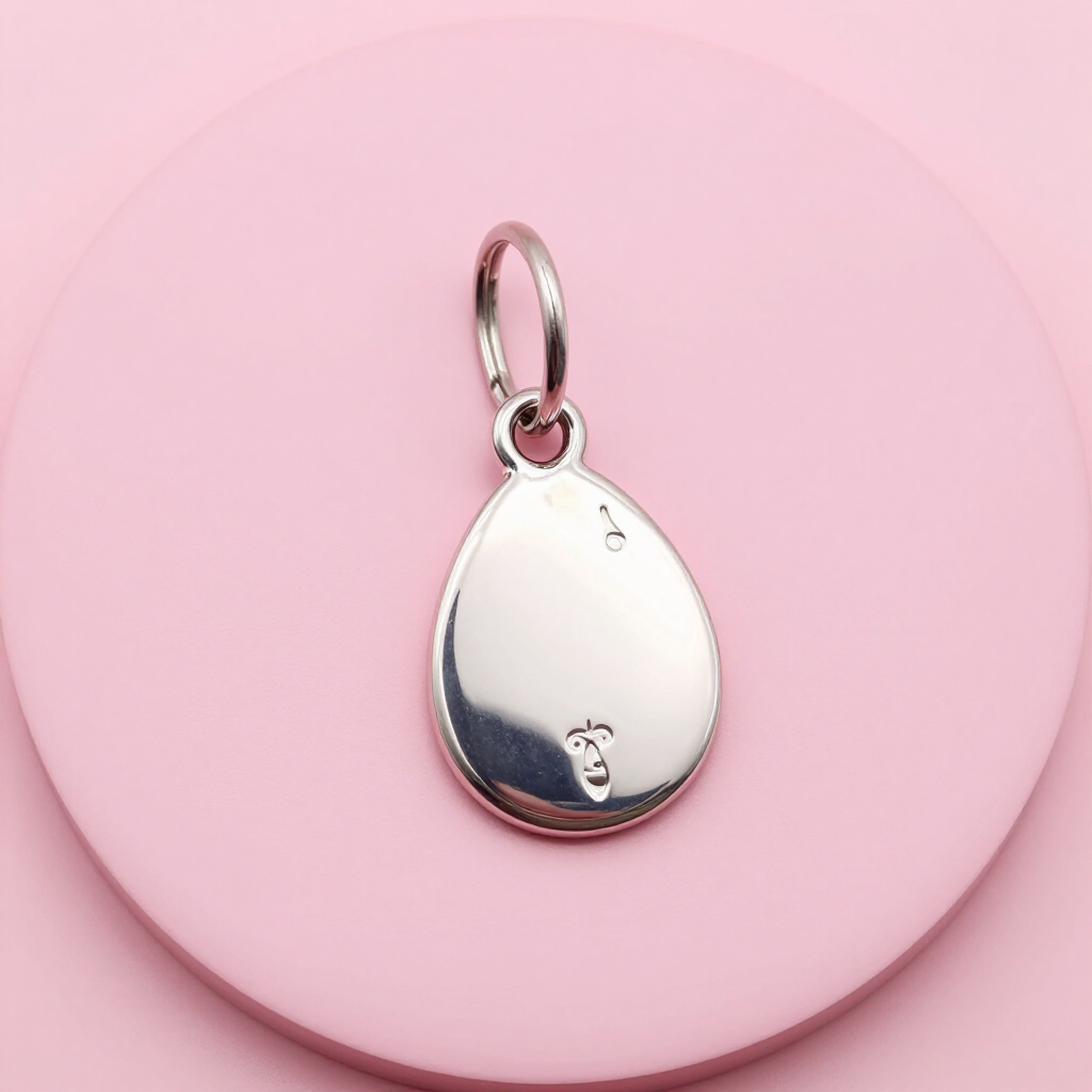 Silver teardrop pendant on a pink circular background