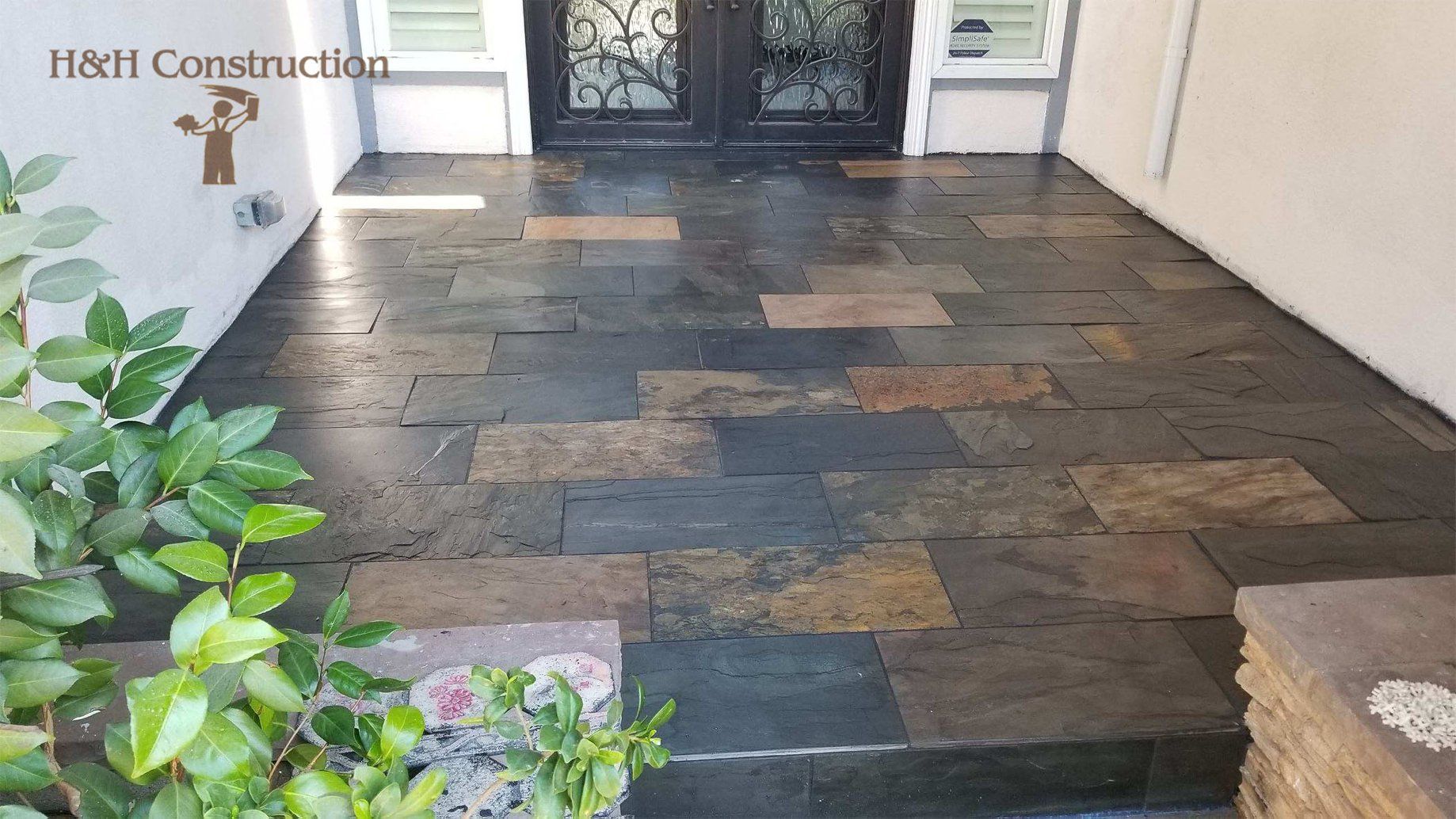 A stone walkway with steps leading up to a door.